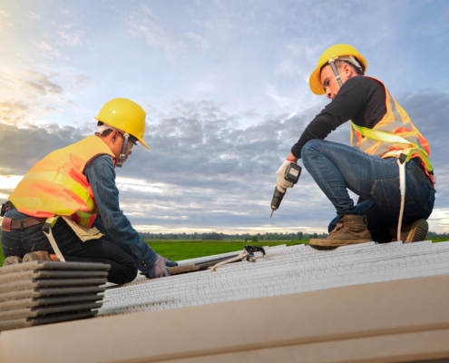 Two workers on commercial roof