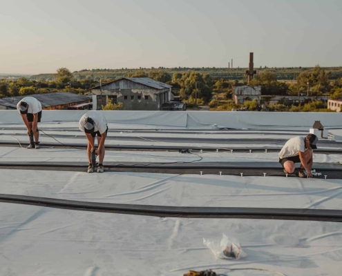 Image of workers fixing a commercial roof.