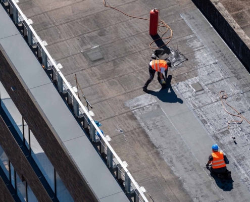 Professional bitumen waterproofing on a flat building