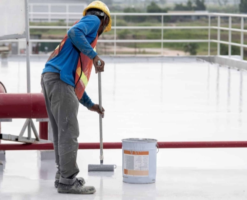 Roof-restoration-worker-applying-tpo-coating