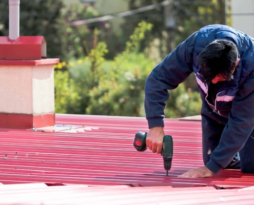 The roofer repairs the roof The roofer repairs the roof_