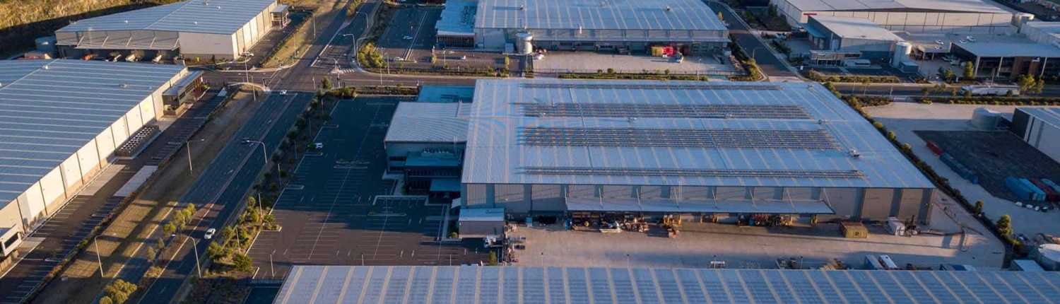 shingles roof of the industrial building with skylights. aerial top view_