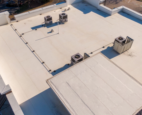 Sunny Day Time Drone Images of a TPO Roof on a Commercial Building